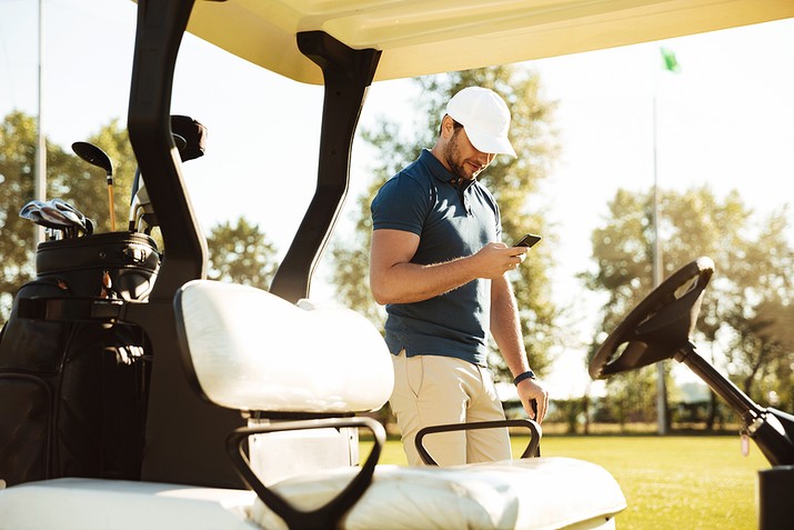Golfer Using Phone on Course