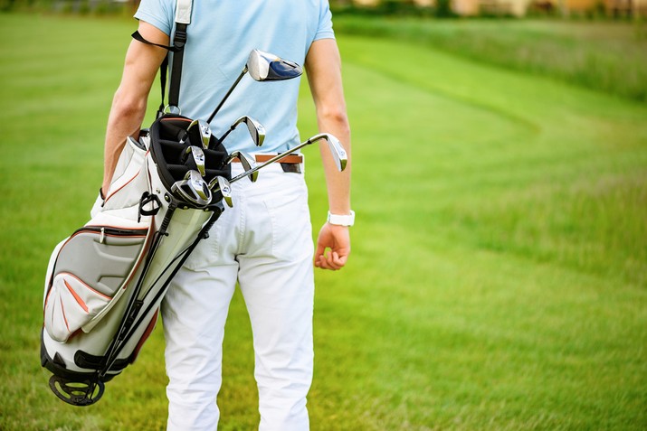 Golfer with Bag Walking on to Course