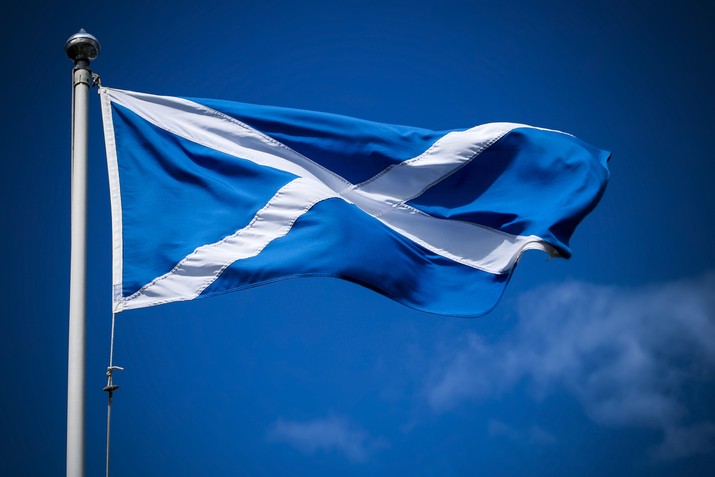 Scottish Flag Against Dark Blue Sky